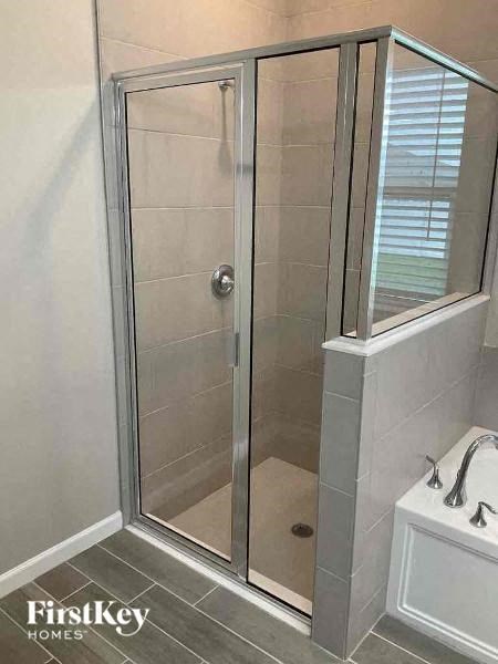 A white bathroom with a glass shower door.