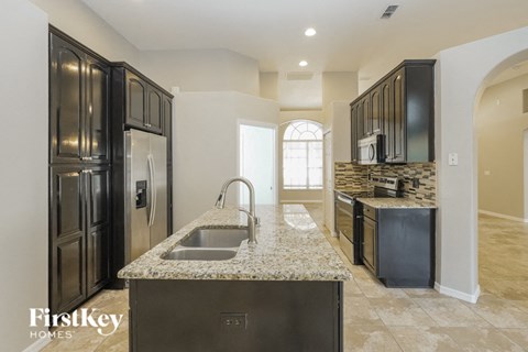 a kitchen with stainless steel appliances and granite counter tops