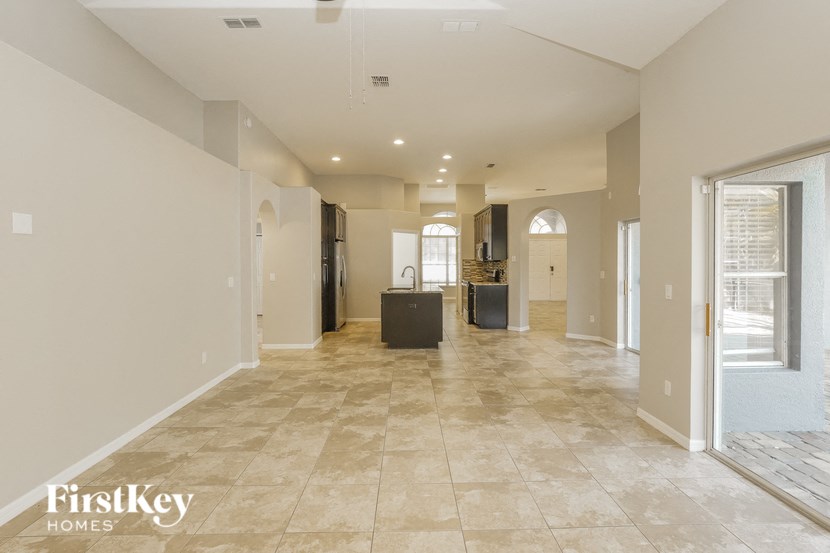the spacious living room and kitchen in a new home