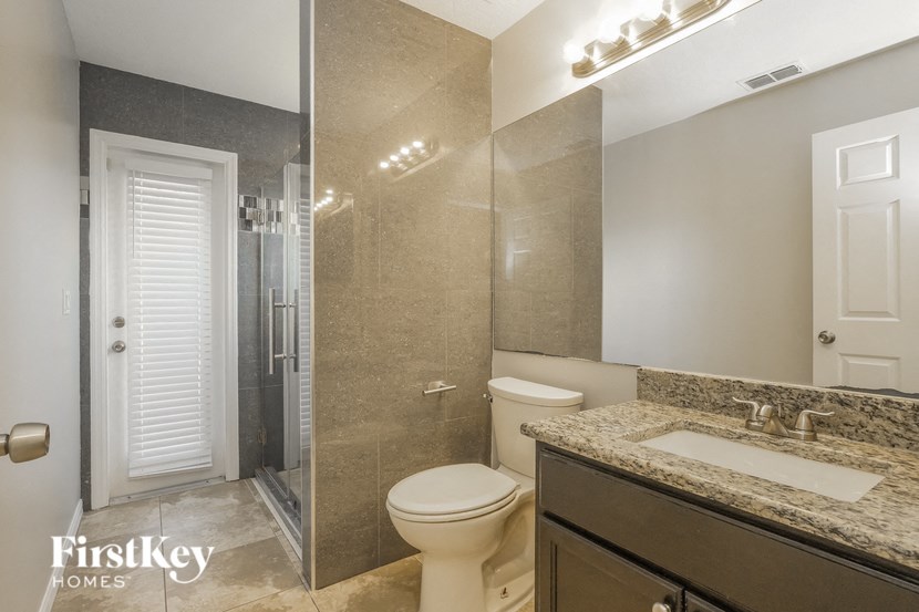 a bathroom with a toilet and a sink and a shower