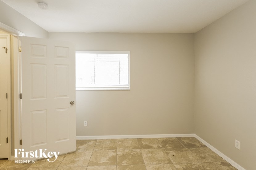 a empty room with a white door and a window