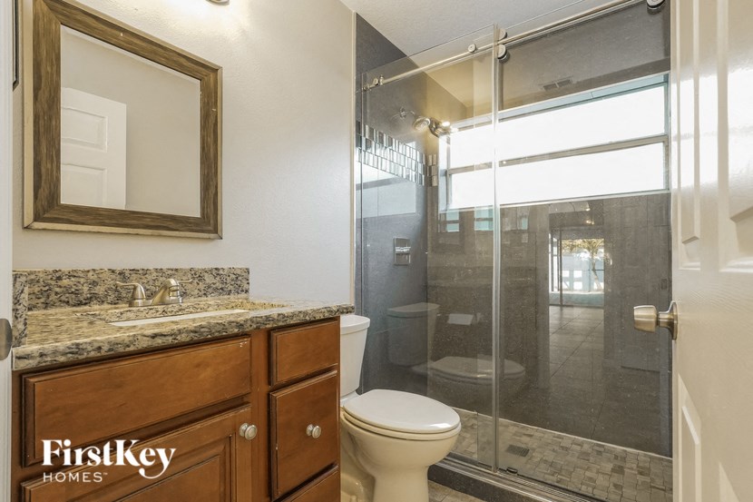 a bathroom with a toilet and a shower