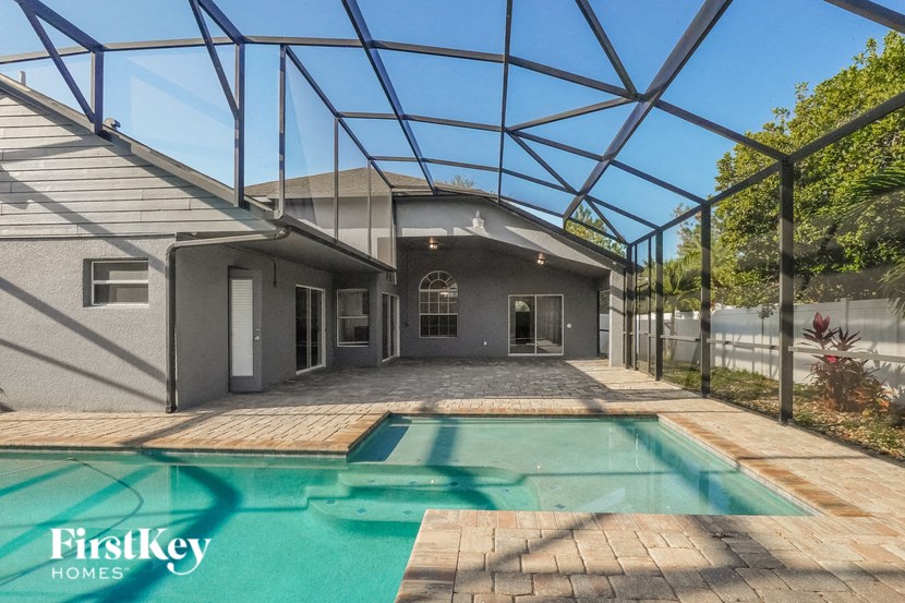 a house with a pool and a glass roof over it