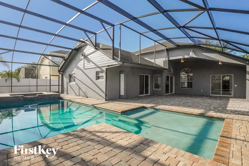 a house with a swimming pool under an enclosure