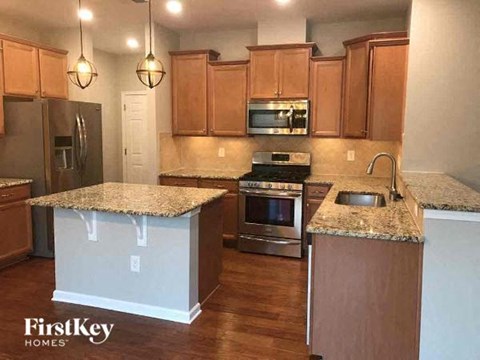 a kitchen with wooden cabinets and granite counter tops