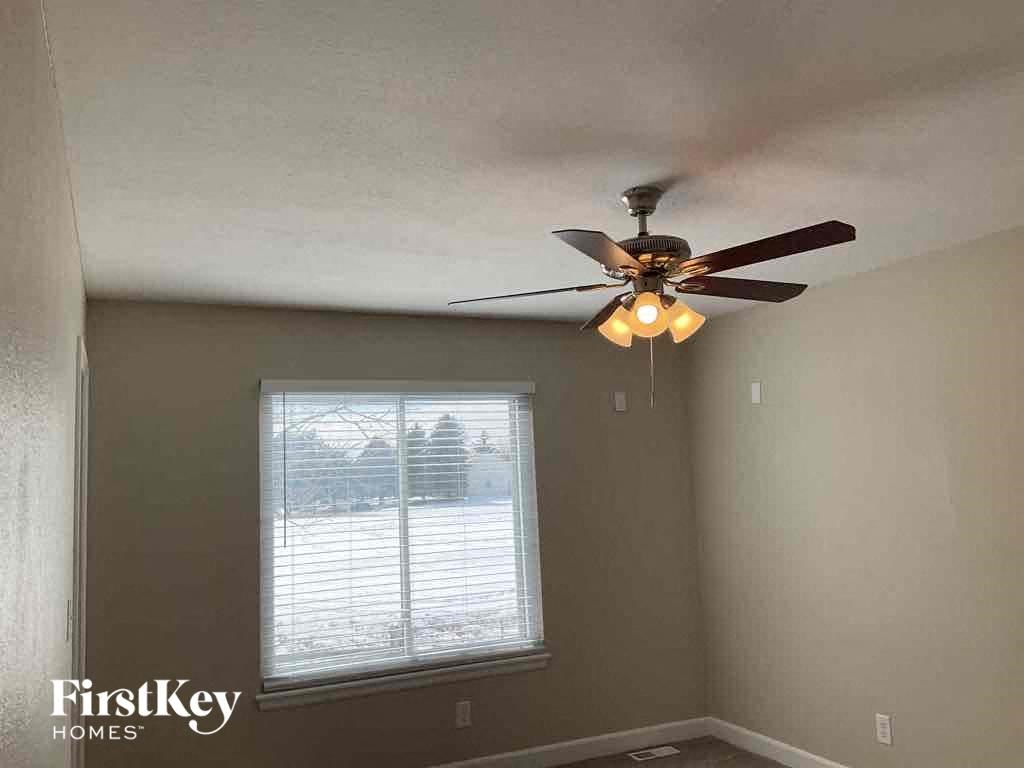 a ceiling fan in a room with a window