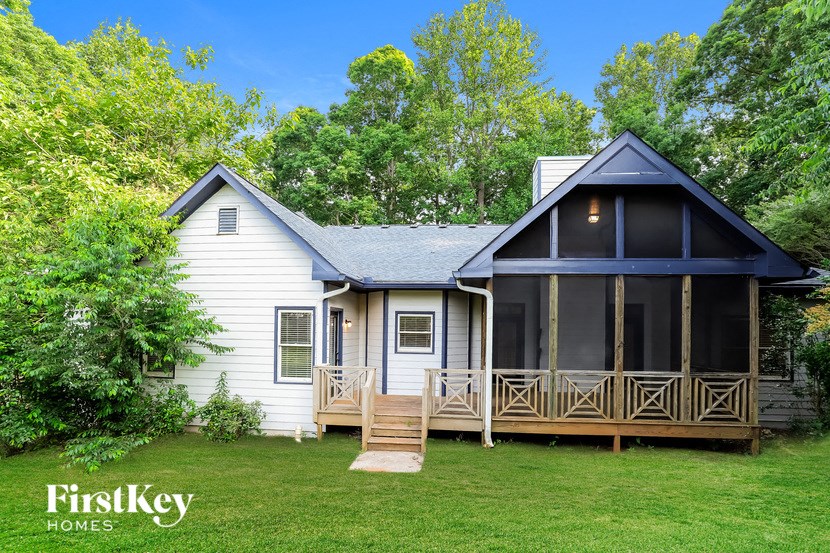 a white house with a porch and a blue roof
