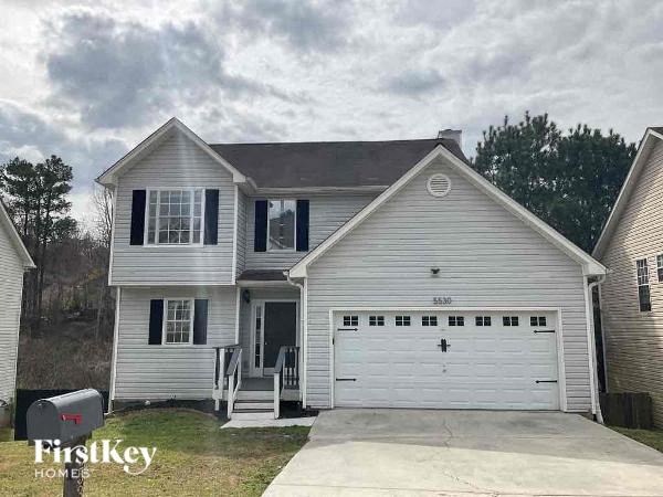 a white house with a white garage door