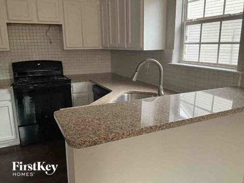 a kitchen with a granite counter top and a sink