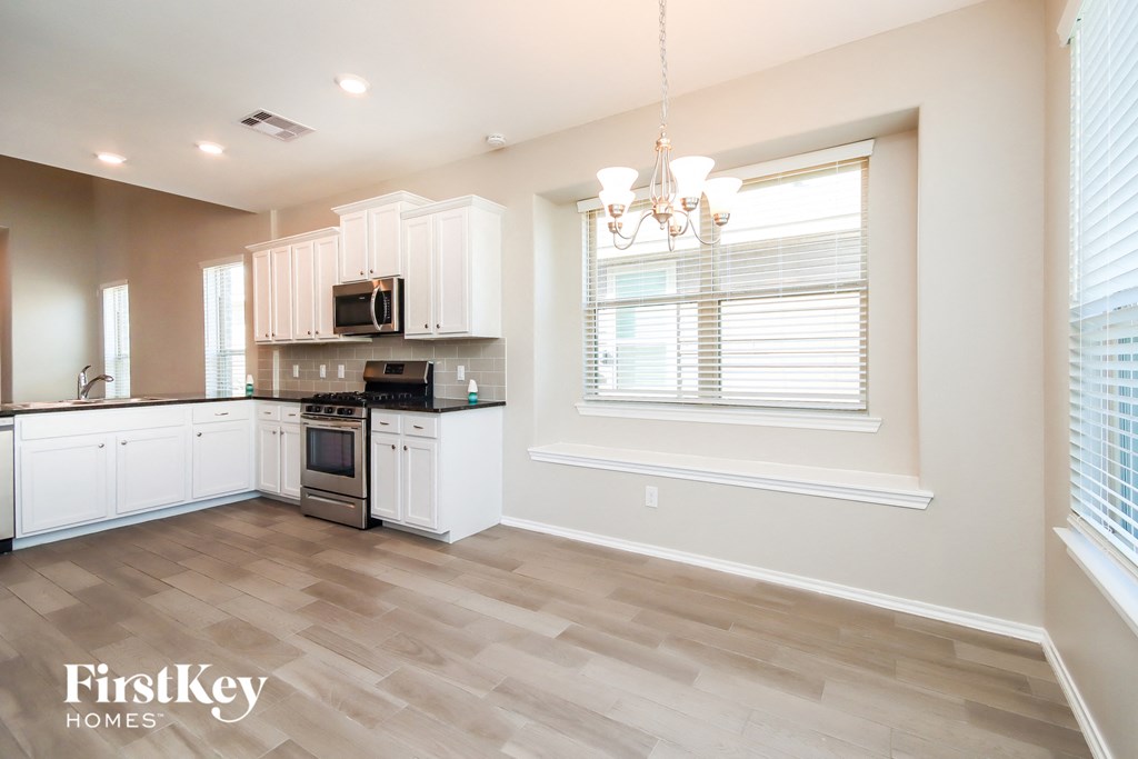 the kitchen is open to the dining room and living room