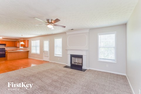 a living room with a fireplace and a rug