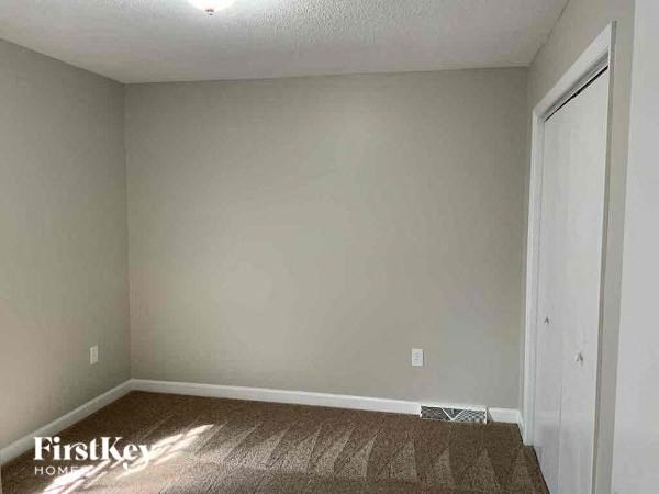 a empty room with a window and a door