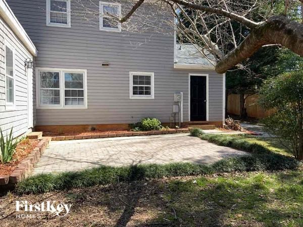 a patio in front of a blue house