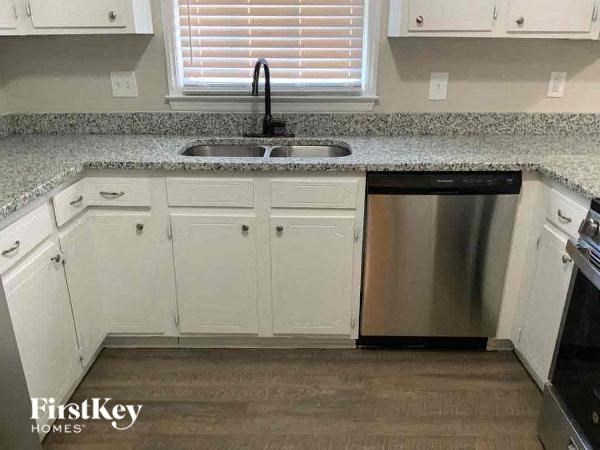 a kitchen with white cabinets and a sink