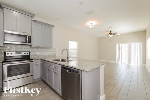 a kitchen with stainless steel appliances and a granite counter top