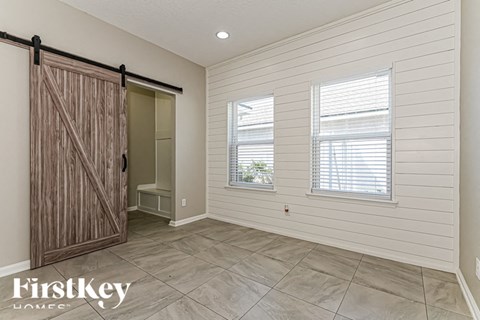 the master bedroom has a large closet with a sliding barn door