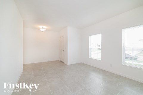 A spacious, empty room with a door and a window.