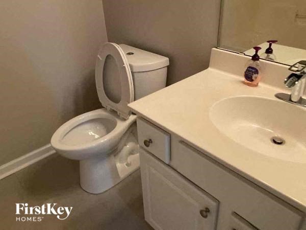 a white bathroom with a toilet and a sink