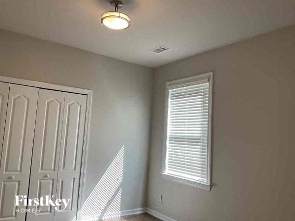 an empty room with a white door and a window