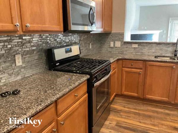 a kitchen with granite counter tops and a stove