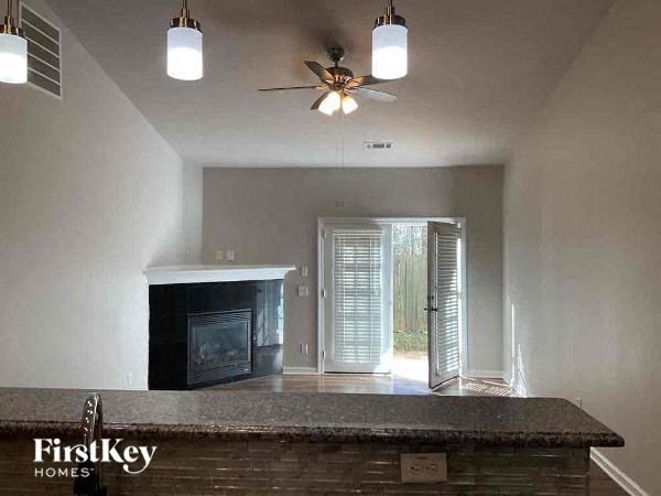 a living room with a bar and a fireplace