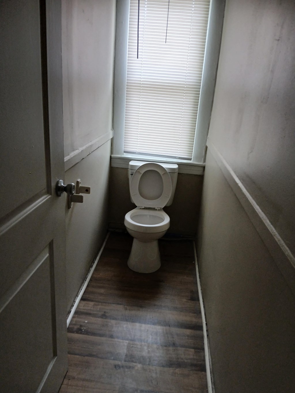 a small bathroom with a toilet and a window