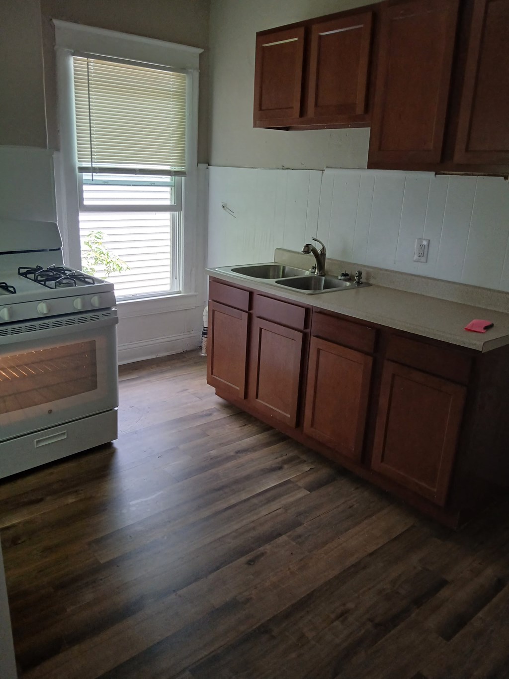 a kitchen with a sink and a stove and a window