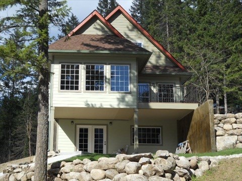 a white house with rocks on the ground