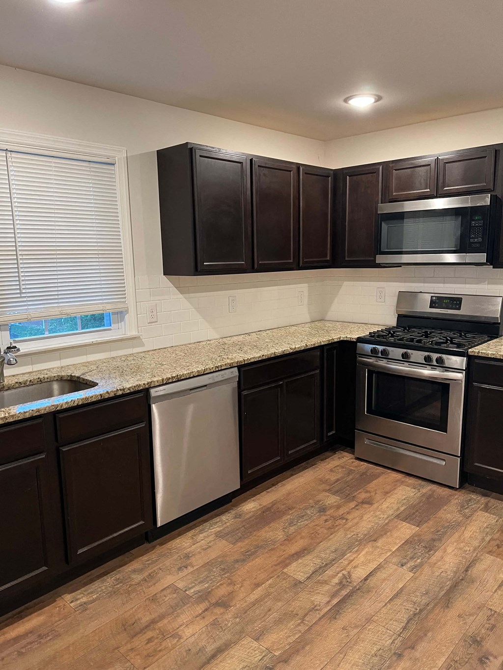 a kitchen with granite counter tops and stainless steel appliances