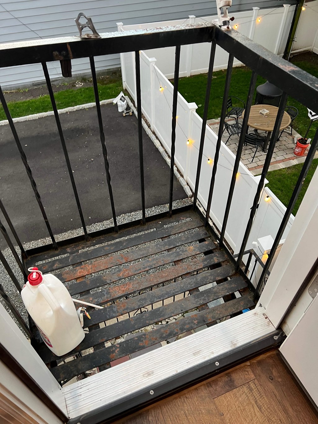 a gallon of milk sitting on the stairs of a balcony