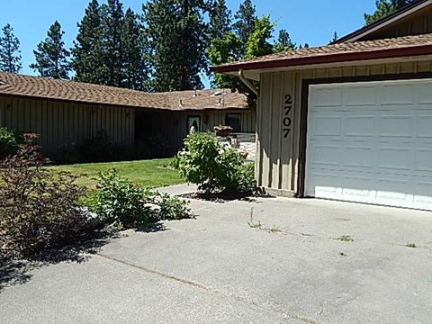 a white garage door in front of a house