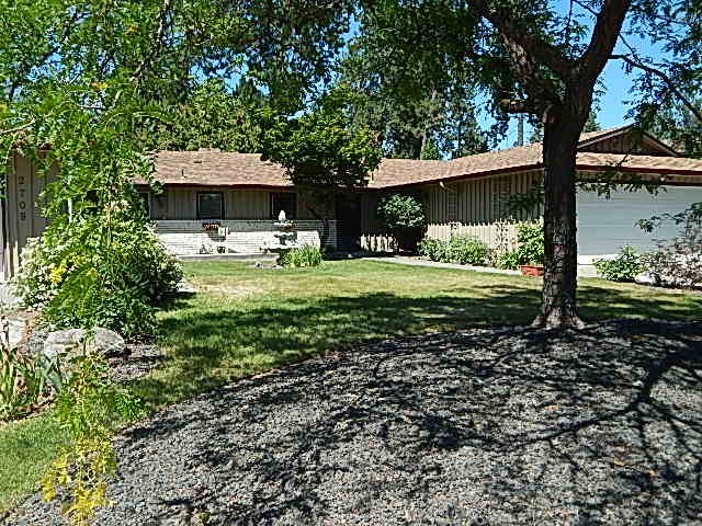 a house with a yard and a tree