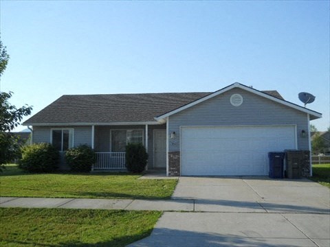 a house with a white garage door and a driveway
