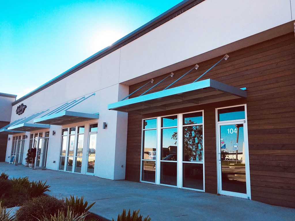 the front of a building with glass doors