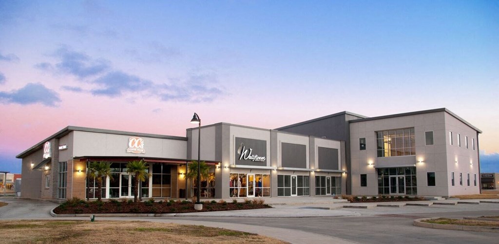 the exterior of a walmart building at sunset