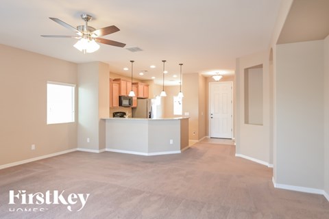 A spacious living room with a television and a bar area.