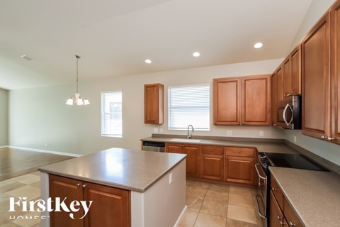 A kitchen with wooden cabinets and a countertop.