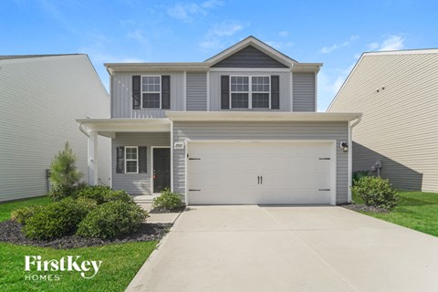a white house with a white garage door