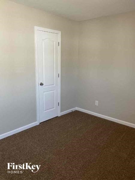 an empty room with a white door in it