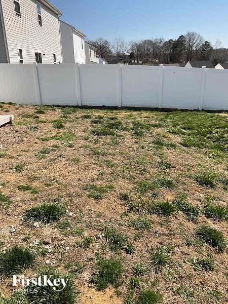 a yard with grass and a fence