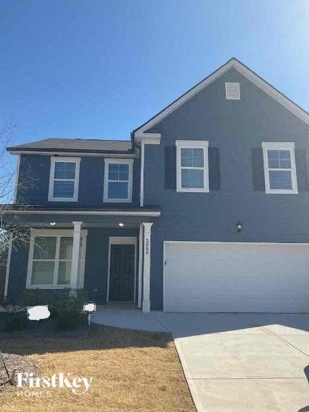 a blue house with a white garage door