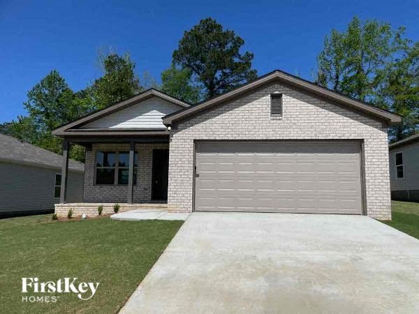 a white brick house with a white garage door