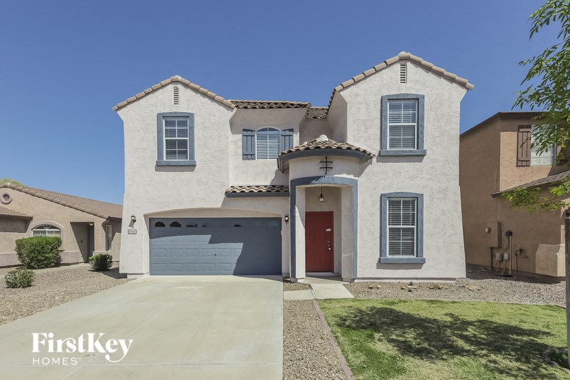 A house with a red door and a garage.