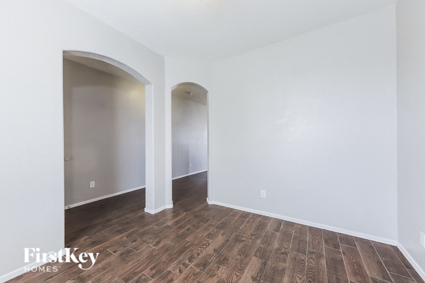 A room with wooden floors and white walls.