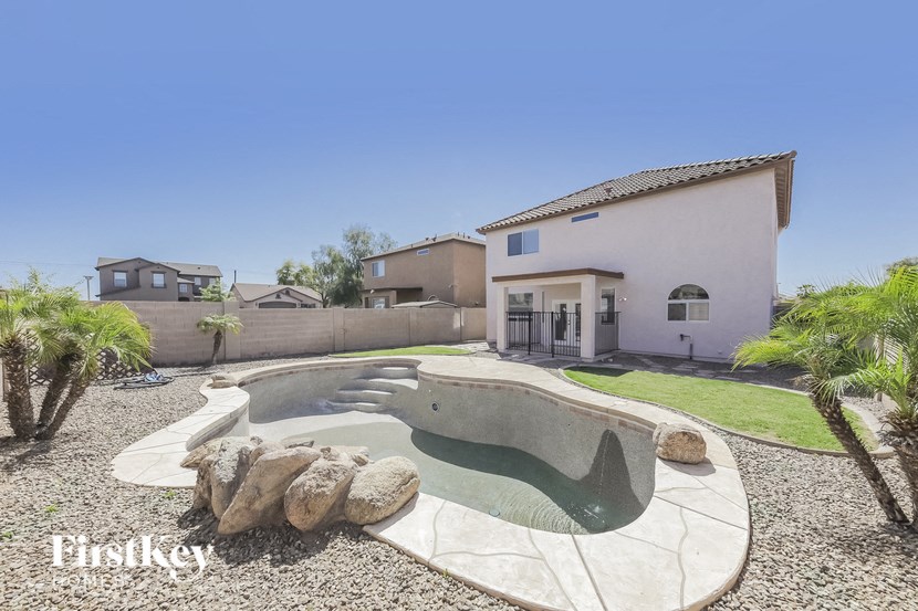 A house with a pool in the backyard.