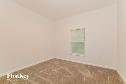the upstairs bedroom has been cleaned and staged with carpet and a window