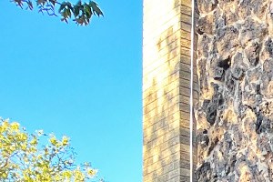 A stone building with a green sign that says Oak Park on it.
