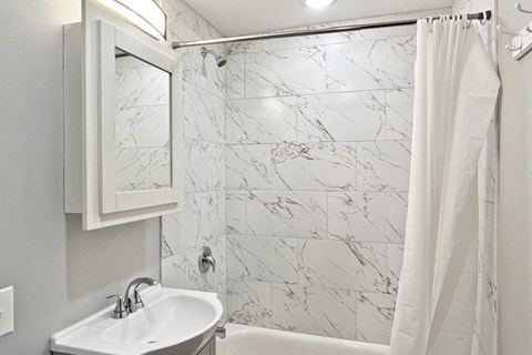 A white sink with a mirror above it.