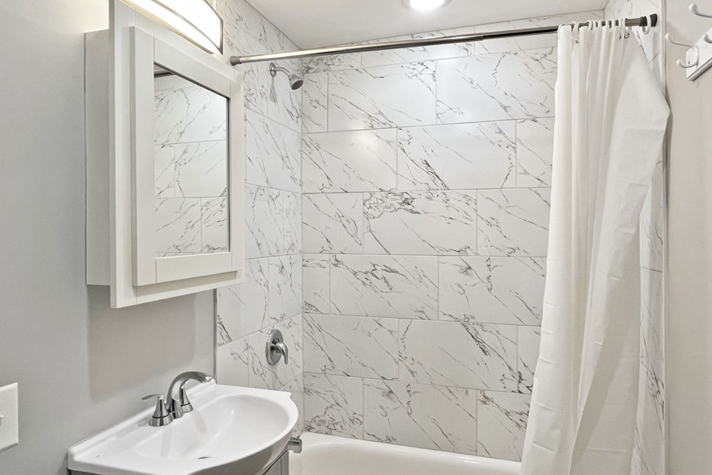 A white sink with a mirror above it.