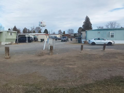 A parking lot with a white car parked in the middle.